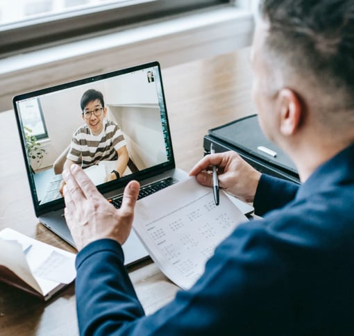 man in online meeting on laptop